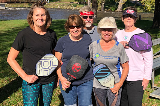 Owatonna Pickleball members holding paddles